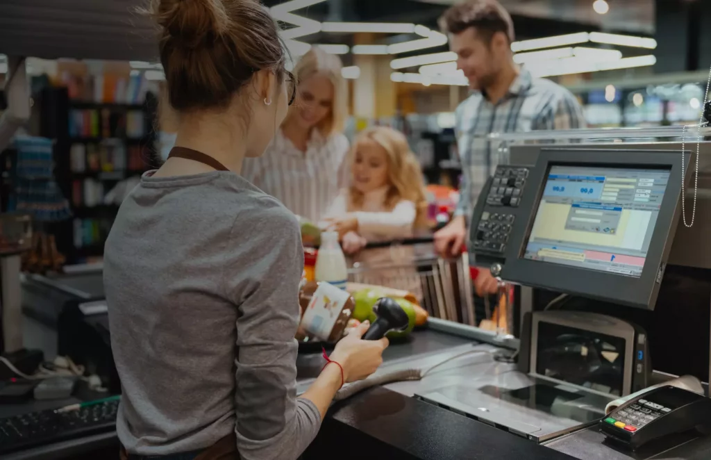 a girl handing customer at retail store